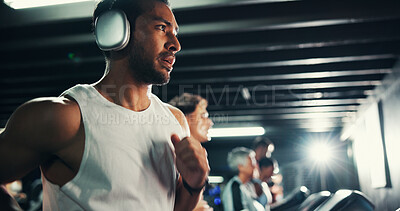 Buy stock photo Exercise, man and running on treadmill with headphones at night for agility training, speed challenge and fitness music. Cardio, evening workout or playlist for calorie burning and performance at gym