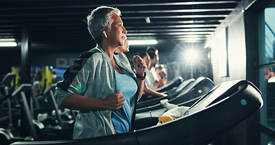 Buy stock photo Runner, earphones and music with woman on treadmill for workout playlist, training club and health. Gym membership, exercise and fitness podcast with mature person on running machine for radio
