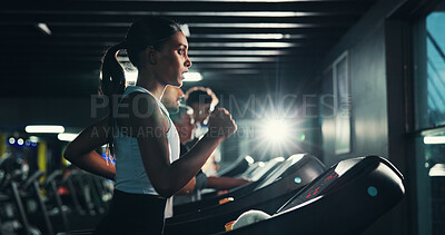 Buy stock photo Energy, woman and running on treadmill in gym at night for agility training, speed development or cardio fitness. Pace, evening workout and girl on machine for marathon exercise or sports performance