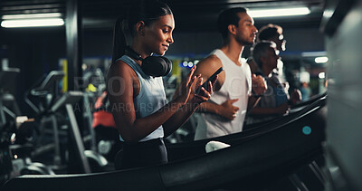 Buy stock photo Runner, phone and music with woman on treadmill for workout playlist, training app and health. Gym membership, exercise and progress check with person on running machine for radio and sports