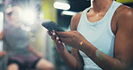 Hands, fitness and woman in gym, smartphone or message to contact, social media or training. Closeup, mobile user or healthy person in wellness center, chatting or cellphone with exercise or progress