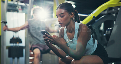 Buy stock photo Fitness, smartphone or woman in gym, internet and online reading with social media, chat or workout. Resting, mobile user or healthy person in wellness center, cellphone or app for exercise goal