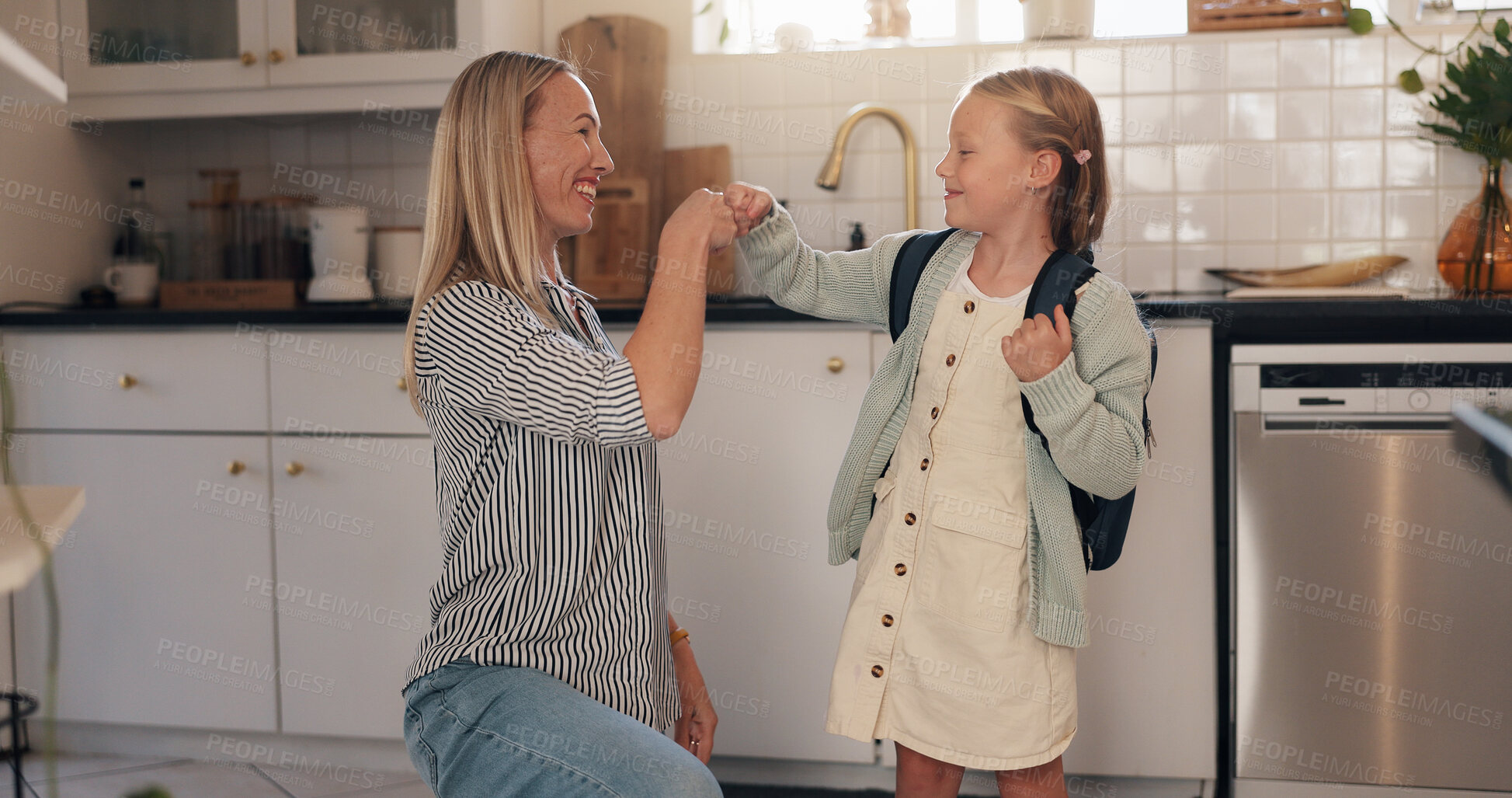 Buy stock photo Fist bump, mother and child with backpack in home for back to school, goodbye and greeting. Morning routine, happy family and people with gesture in kitchen for study support and ready for education