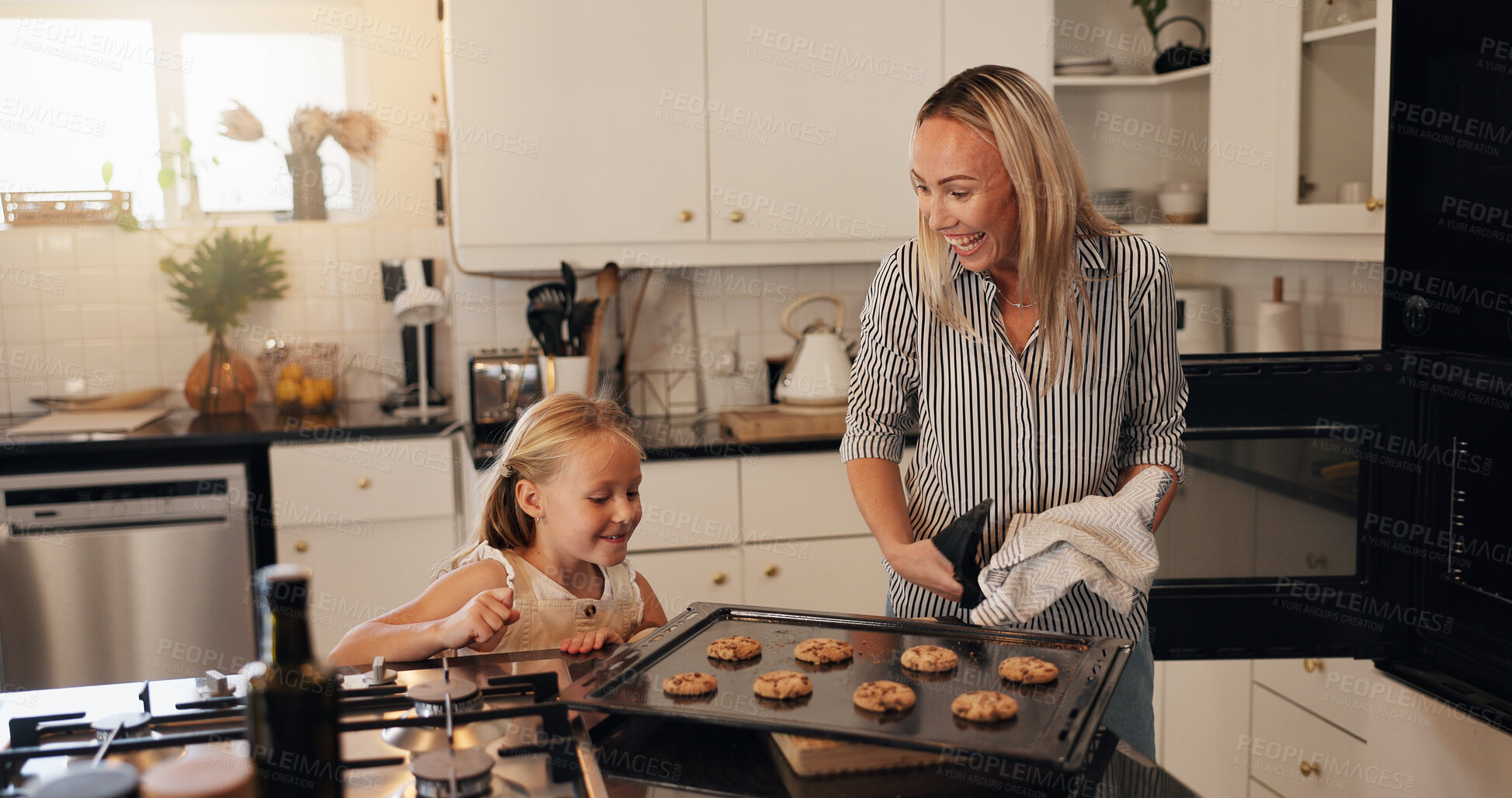Buy stock photo Baking, child and mom with cookies in kitchen, teaching and helping daughter with meal prep in home. Excited, woman and showing dessert to kid, family and happy for culinary skills in apartment