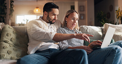 Buy stock photo Couple, laptop and relax on sofa in home with point, talk and choice for film, streaming or series. People, man and woman with computer for movie, show or subscription on couch in lounge at apartment
