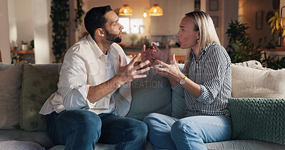 Buy stock photo Home, sofa and couple with conflict in marriage, toxic relationship and disagreement for divorce. Night, man and sad woman with fight for separation, breakup and communication problem in living room
