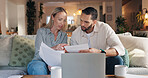 Home, couple and laptop with stress for document, financial bills and problem solving for budget. Sofa, woman and man with paperwork for tax deduction, mortgage expenses and discussion in living room