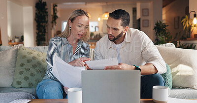 Buy stock photo Home, couple and laptop with talking for document, financial bills and problem solving for budget. Sofa, woman and man with paperwork for tax deduction, mortgage expenses or discussion in living room