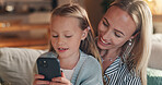 Home, mother and girl with smartphone, smile and bonding together with online entertainment. Happy family, cellphone and parent on sofa, mama or daughter with tech, internet or help with social media