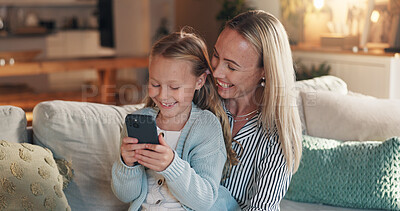 Buy stock photo Home, mother and girl with cellphone, smile and bonding together with online entertainment. Happy family, smartphone and parent on couch, mama and daughter with technology, love and education app