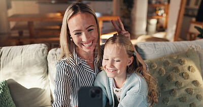 Buy stock photo Mom, girl and happy with selfie on couch, memory and hug with care, love and bonding in family home. People, mother and daughter with photography, profile picture or relax with social media at house