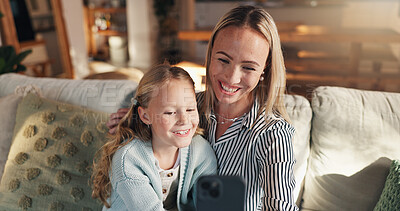 Buy stock photo Mom, girl and hug with selfie on couch, memory and happy with care, love and bonding in family home. People, mother and daughter with photography, profile picture or embrace for social media at house