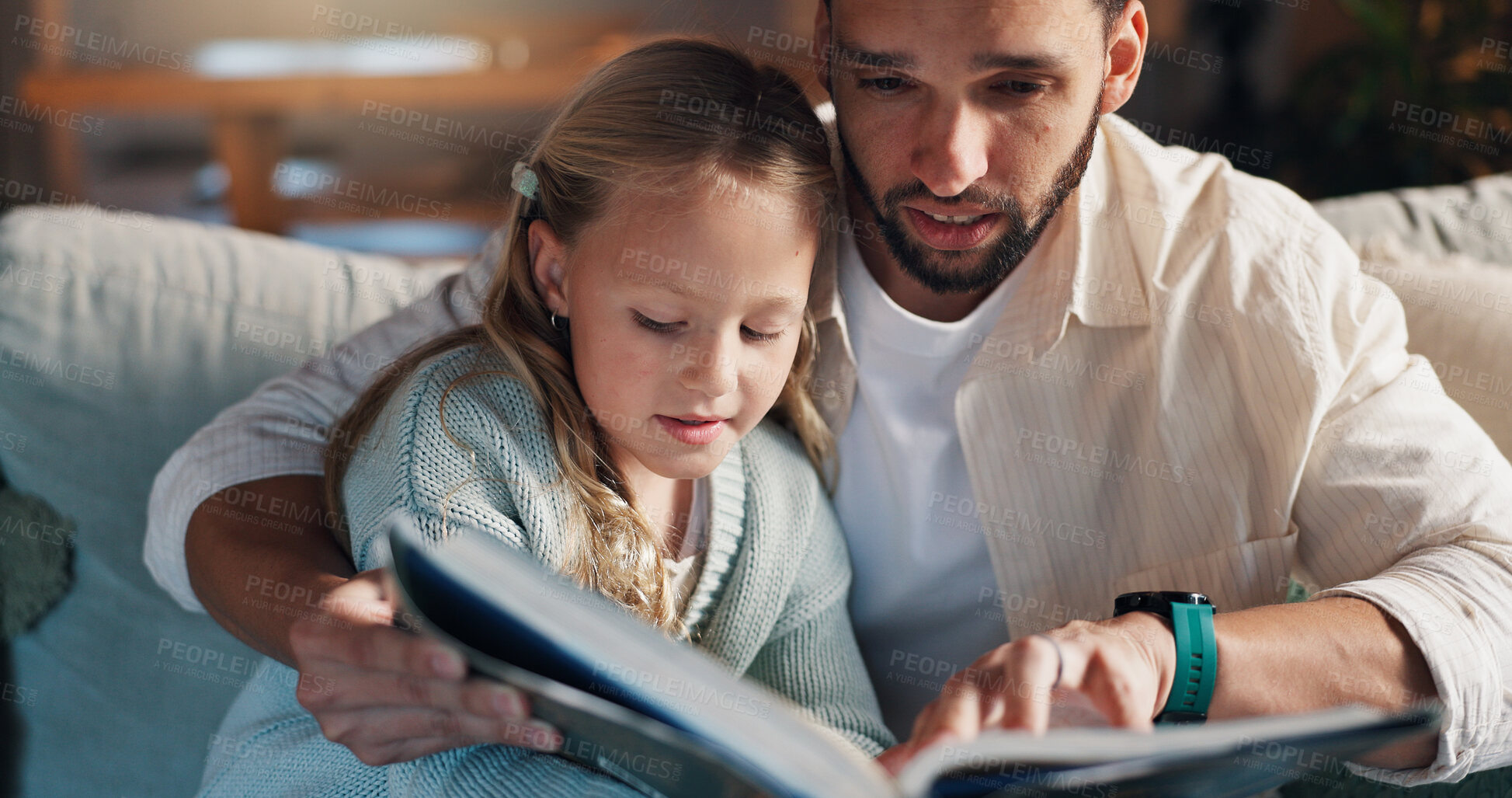Buy stock photo Dad, girl and reading book on sofa, learning and support with development, love and bonding in lounge. People, father and child with literature, education and helping hand on couch at family house