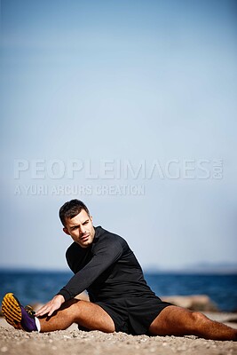 Buy stock photo Man, stretching and wellness at beach for exercise with fitness motivation, sand and blue sky. Male person, training and nature by ocean with workout for sports, strong body and health activity