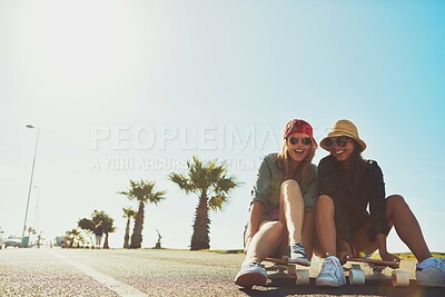 Buy stock photo Space, friends and women on road with skateboard for holiday travel, funny joke or vacation trip. Smile, sky or happy people at beach laughing on break for outdoor activity, bonding or fun adventure