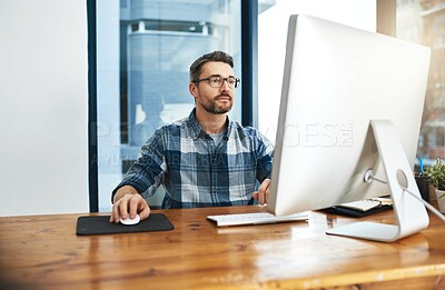Buy stock photo Cropped shot of a businessman working on his computer in the office