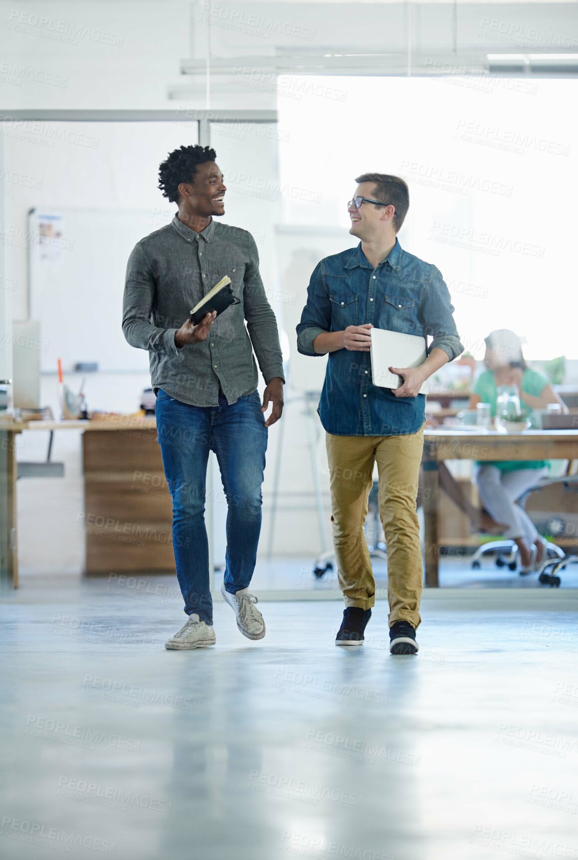 Buy stock photo Creative, coworkers and walking or talking in office together, employees and notebooks or strategy planning conversation. Business, partnership and company communication, collaboration for growth