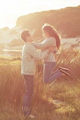 Buy stock photo Sunset, nature and man lift woman for celebration on romantic vacation or holiday together. Happy, love and couple jump for relationship anniversary in evening on countryside weekend trip in Italy.