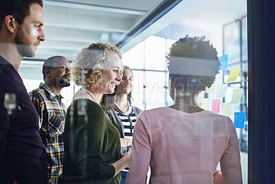 Buy stock photo Creative people, meeting and schedule planning with team on glass board for brainstorming or strategy at office. Young group of employees in discussion for reminder, tasks or collaboration in startup