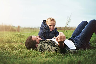 Buy stock photo Family, grass and father with baby in park for bonding, playing and laugh together outdoors. Nature, field and happy dad relax with young boy for child development, love or fun on weekend or holiday