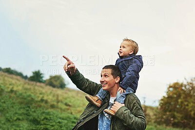 Buy stock photo Pointing, father and child on shoulder in nature with happy smile, grass and bonding in outdoor garden. Man, son and playful learning in backyard for growth, development and fun with care in park