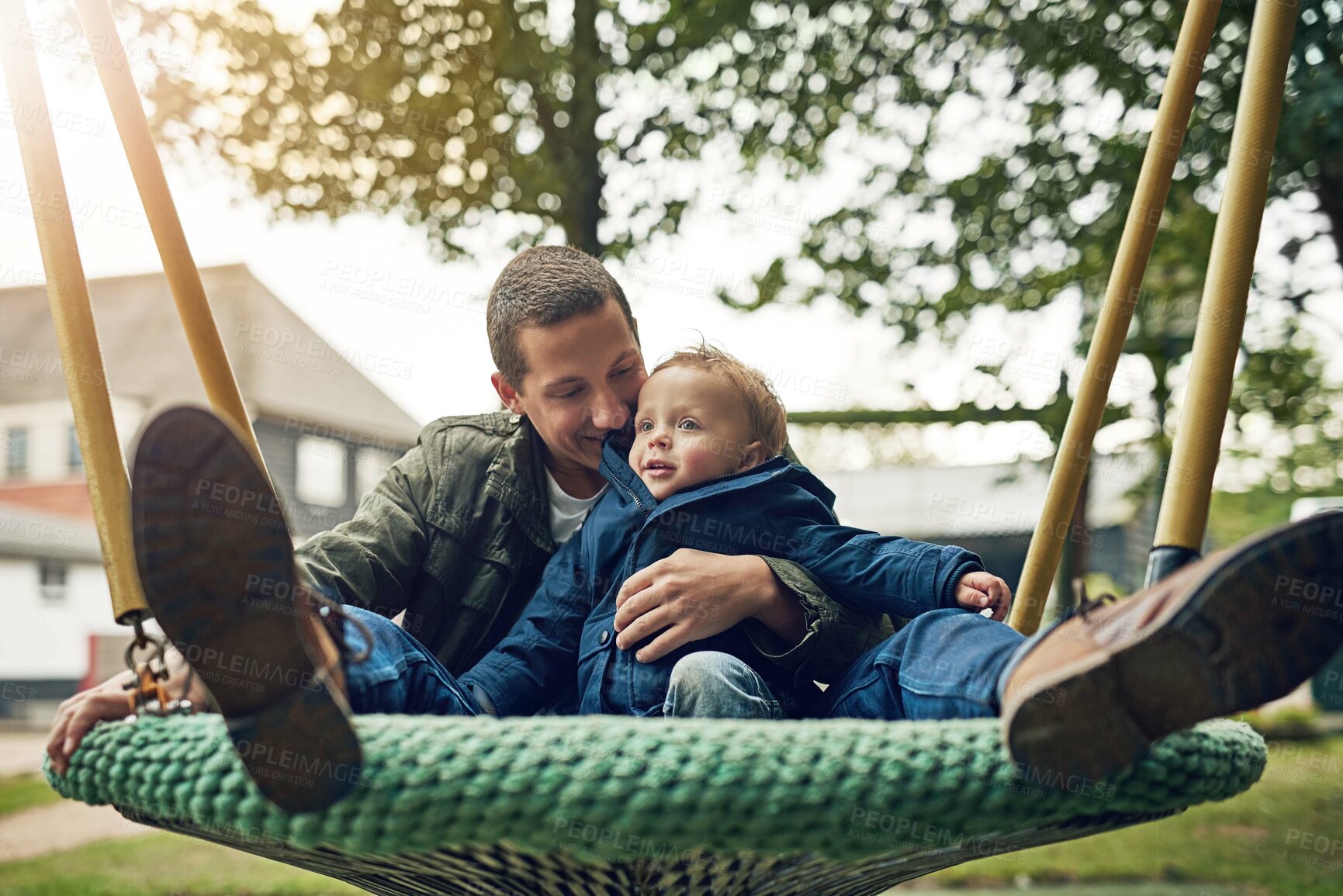 Buy stock photo Dad, child and playing together in swing with happy smile, nature and bonding in outdoor garden. Father, son and playful games in backyard for growth, development and fun with energy, smile and care.