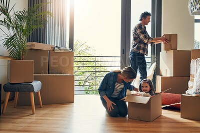 Buy stock photo Moving, boxes and parents with kid in new home bonding together for family time at property. Relocation, mortgage and girl child play with mom and dad and unpacking cardboard package for house.