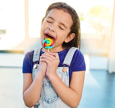 Buy stock photo Candy, lollipop and kid with sweets in home for dessert, food and eating sugar with eyes closed. Cute girl, child and lick sucker, treats or hungry for unhealthy rainbow color confectionery snack 