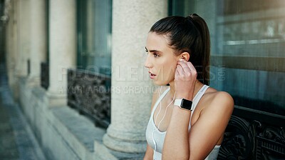 Buy stock photo Earphones, woman or athlete in city ready for workout, training or outdoor exercise with radio music. Sports podcast, break or runner listening to audio for energy, wellness or fitness in England