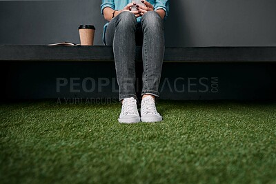 Buy stock photo Legs, coffee and social media on bench for communication, texting and notebook for planning. Person, smartphone and relax on seat for networking, scrolling and contact on technology by astro turf