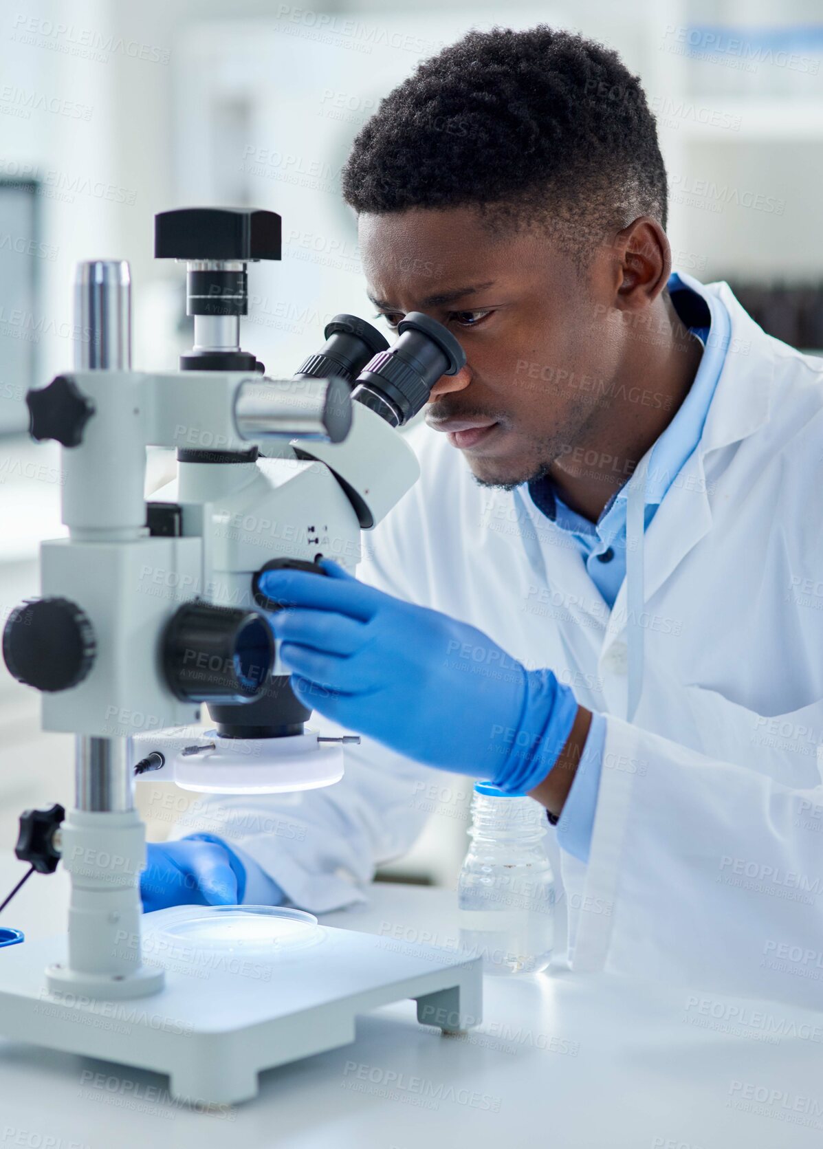 Buy stock photo Black man, scientist and microscope in lab with analysis for test sample, experiment and dna pattern. Person, gloves and ppe for medical research at pharma company with thinking, gear and innovation