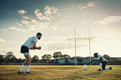 Buy stock photo Fitness, kicking and rugby with team of people outdoor on field together for competition or challenge. Ball, goal and training with sports player group on grass for exercise, game or match practice