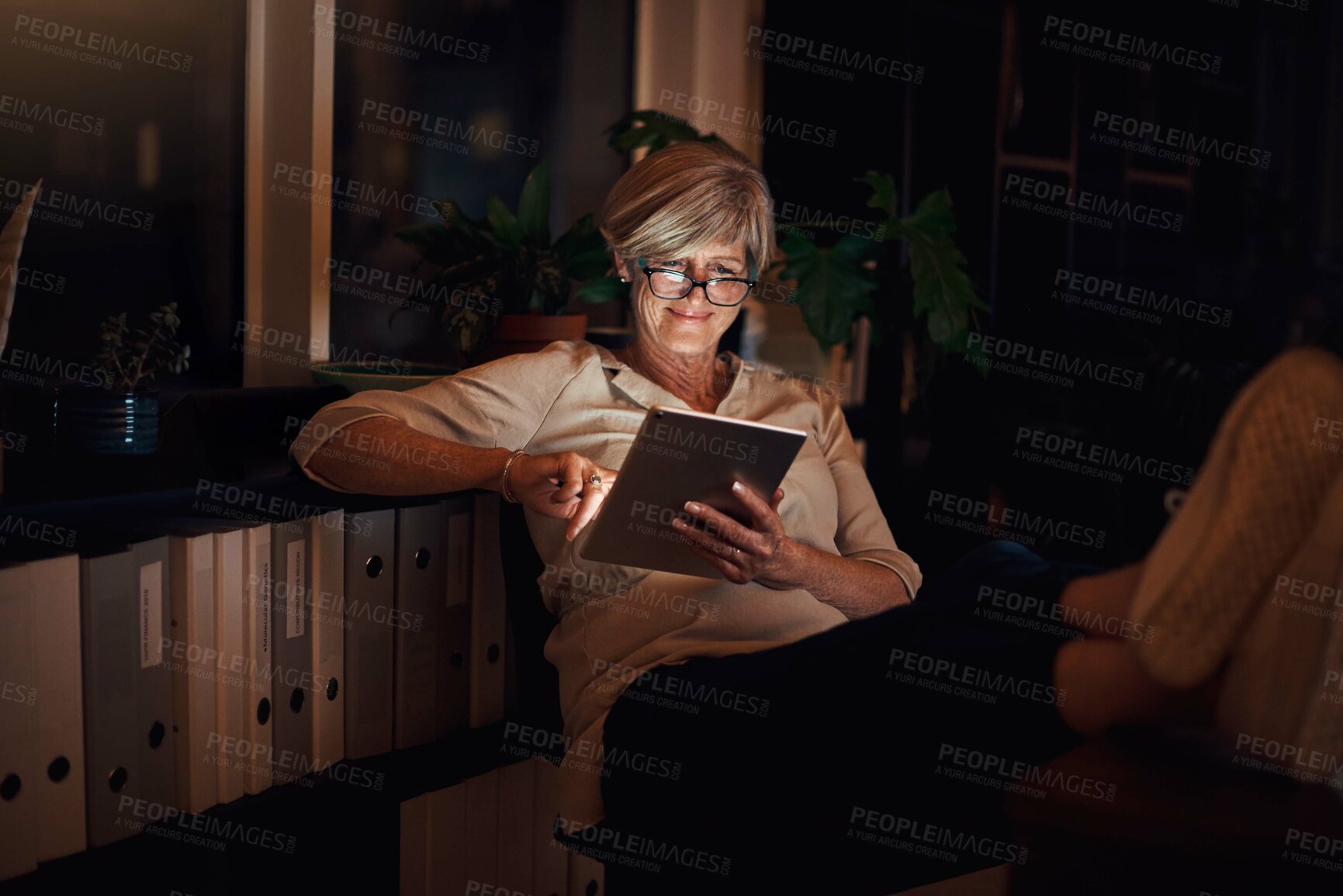 Buy stock photo Business, tablet and mature woman in office with relax for notification, web blog or comfortable with research. Reading, night and employee with glasses for information, email or online news article