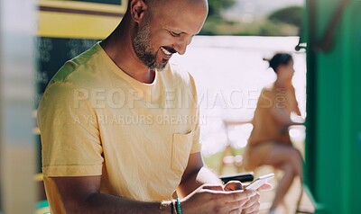Buy stock photo Man, cellphone and happy at outdoor cafe for connection, typing and online reading for research. Male person, technology and communication in coffee shop by lake for social media and streaming 