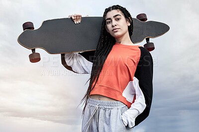 Buy stock photo Skateboard, clouds and portrait of woman with fashion for skating with casual, trendy and cool outfit. Serious, sky and female skater with confidence for hobby and street style in California.