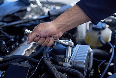 Buy stock photo High angle shot of an unrecognizable male mechanic working on the engine of a car during a service