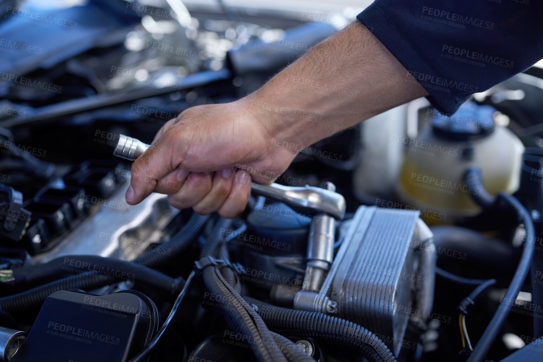 Buy stock photo High angle shot of an unrecognizable male mechanic working on the engine of a car during a service