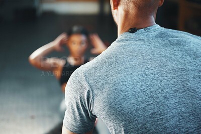 Buy stock photo Closeup shot of a personal trainer assisting a client in a gym