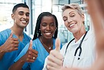 Selfie, doctor and students with thumbs up portrait at hospital for success, diversity and healthcare. Interracial, teamwork and agreement of professional medical people with smile for cooperation.

