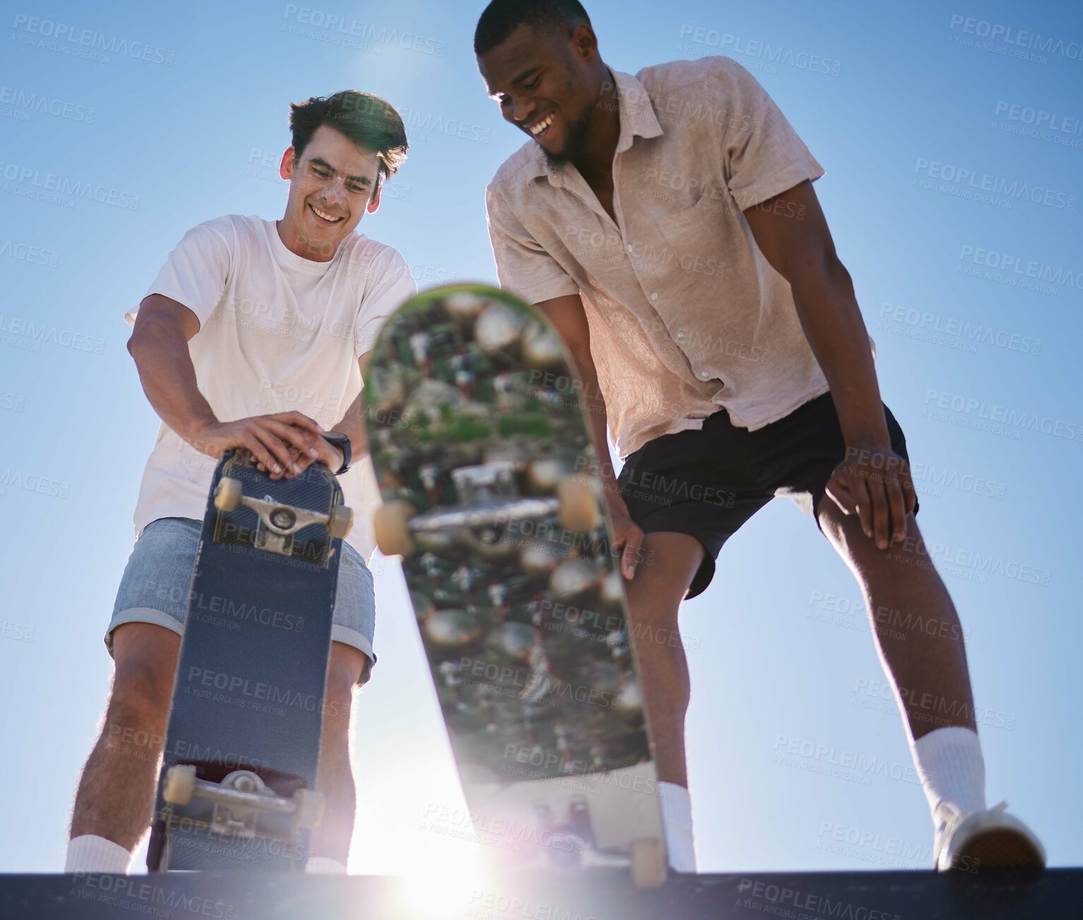 Buy stock photo Skateboarder man, friends smile and relax together at skatepark in summer with lens flare outdoor. Black man, friend and skateboard with sports happiness while tired in urban sunshine with diversity