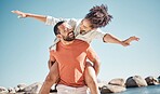 Travel, happy and beach with couple and piggy back for freedom, summer and bonding. Smile, playful and airplane with man carry woman by ocean for love affection, energy and adventure on holiday 