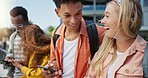 Friends, students and phone with laughing at college, campus or happy for diversity, learning or development. Gen z couple. women and men on mobile app, web chat or meme on social media in university