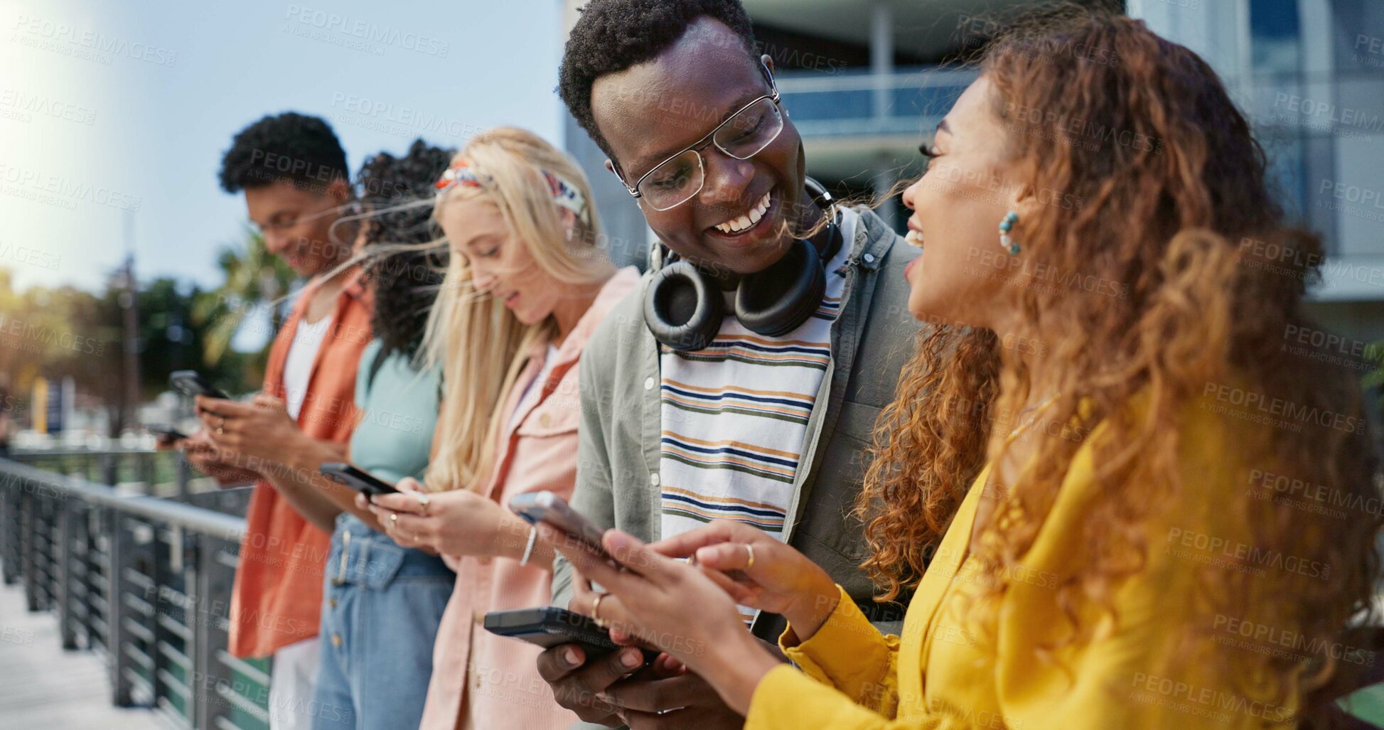 Buy stock photo Friends, students and happy with phone at college, campus or laughing for diversity, learning or development. Gen z group, women and men on mobile app, web chat and meme on social media in university