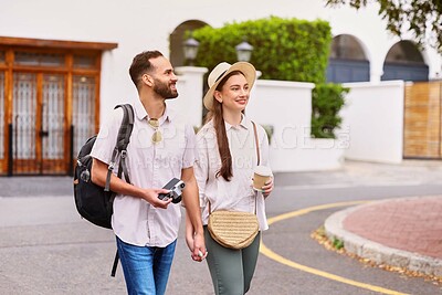 Buy stock photo Happy, couple and tourist with camera outdoor for adventure, sightseeing and walking with holding hands. Man, woman and equipment for photography on tour, cultural experience and travel documentation