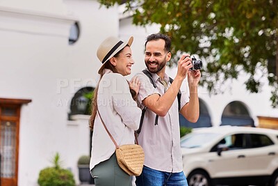 Buy stock photo Smile, couple and tourist with photography outdoor for adventure, sightseeing and together for holiday. Man, woman and camera for pictures on tour, cultural experience and travel documentation.