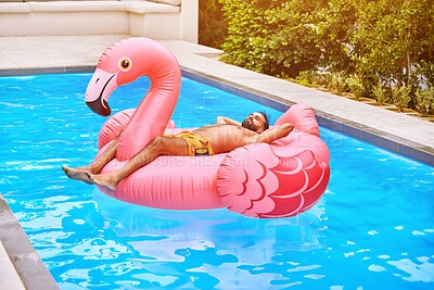 Buy stock photo Man, summer and flamingo in swimming pool for holiday, wellness and relax for vacation. Male person, sunshine and inflatable bird in water for travel, calm or zen and float for weekend trip to Miami