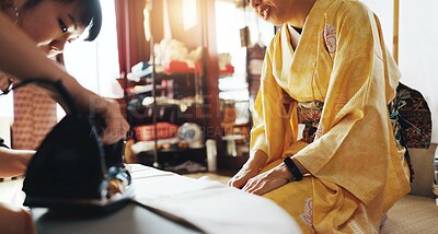 Buy stock photo Fashion designer, seamstress and Asian women in workshop with iron for heat, steam or clothing press. Small business, boutique and people with material, fabric or textiles for tailor service in Japan