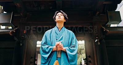 Buy stock photo Kimono, culture and low angle with Japanese man at temple for Shinto ceremony, fashion and prayer. Respect, travel and reflection with person in japan for traditional clothes, Buddhism and festival