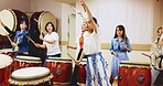 Japanese, drums and people in performance for music on instrument for stage practice, creativity or talent. Taiko, women and female drummers in band to play in rehearsal for culture, rhythm or beat