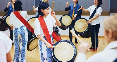Buy stock photo Japanese, learning or people with drums for music on instrument for performance, creativity or class. Taiko, woman or female drummers in band to play in practice rehearsal for culture, rhythm or beat